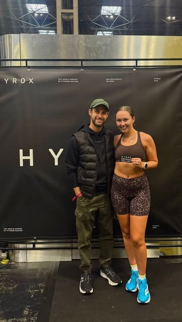 Two LowFlo members smiling together at a HYROX event